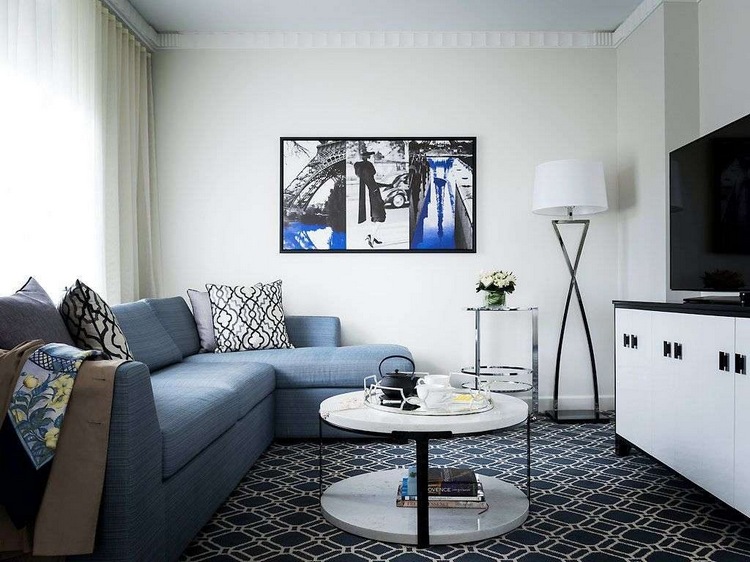 Синий диван в белом интерьере гостиной городской квартиры